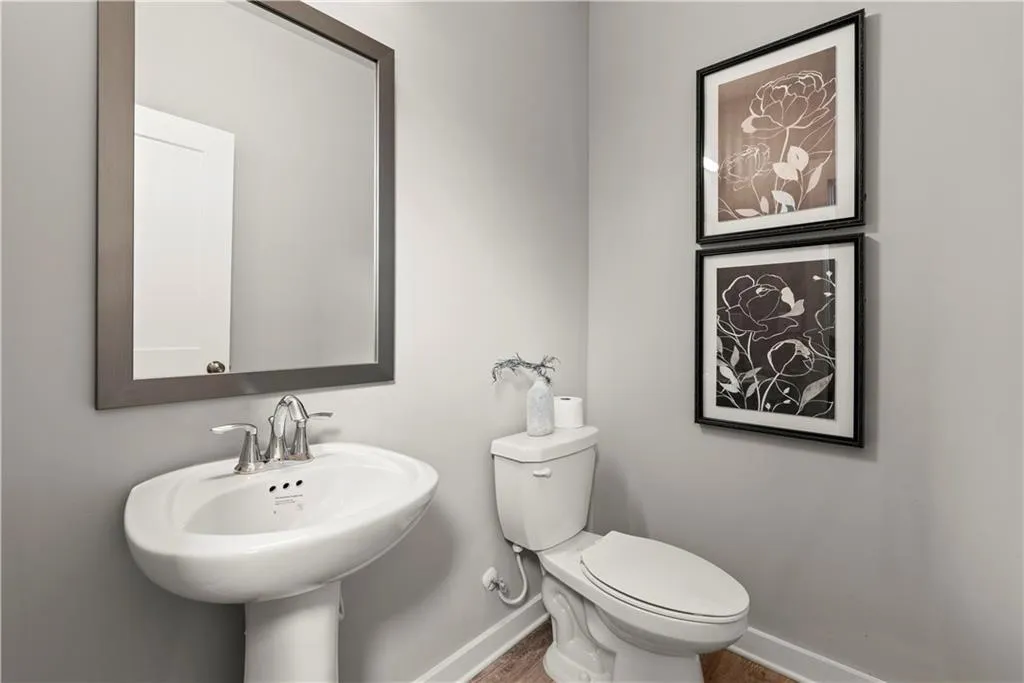 Half bath with baseboards and toilet