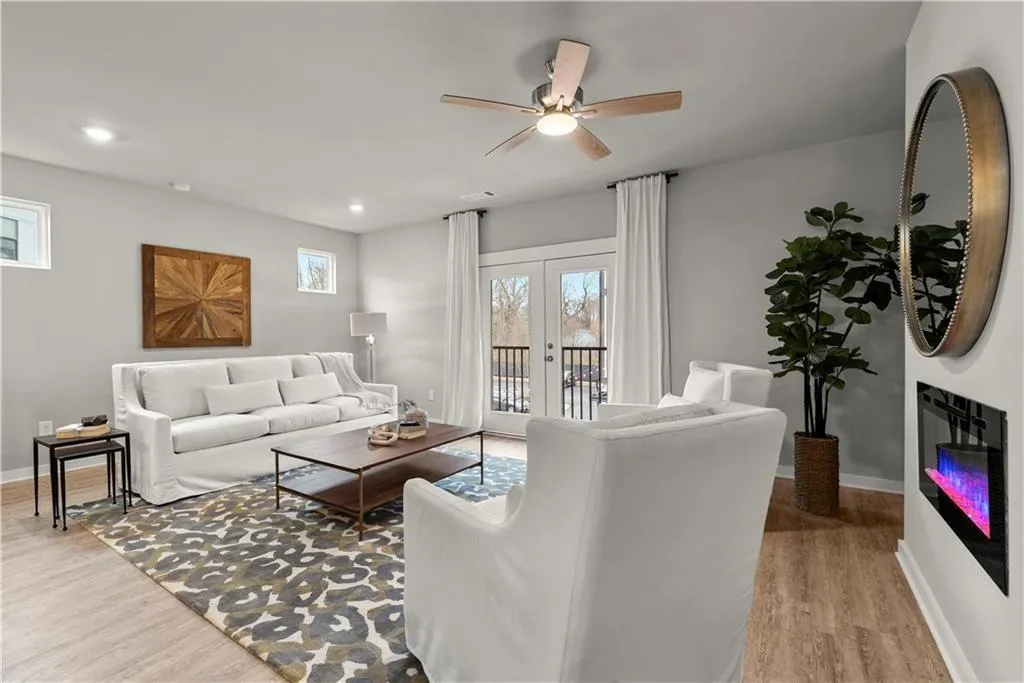 Living area with french doors, light wood finished floors, a ceiling fan, and recessed lighting