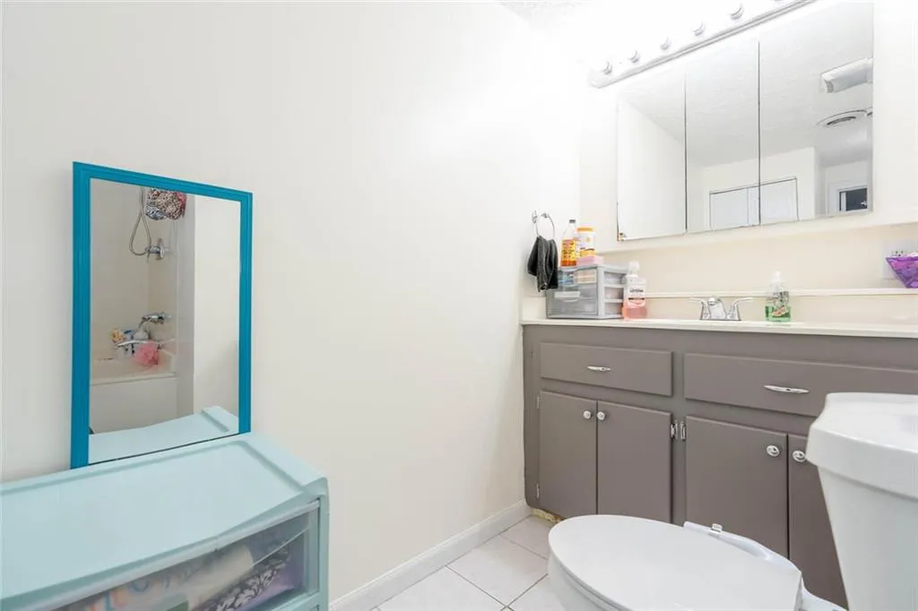 Bathroom with vanity, tile patterned flooring, toilet