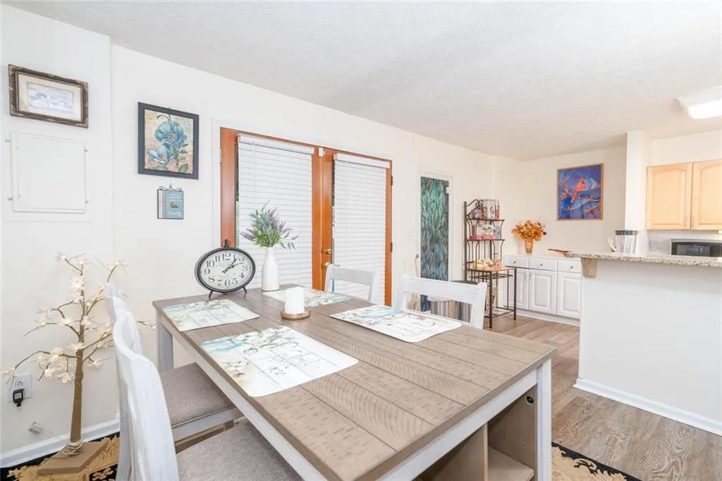 Dining room with french doors, and light wood-type flooring