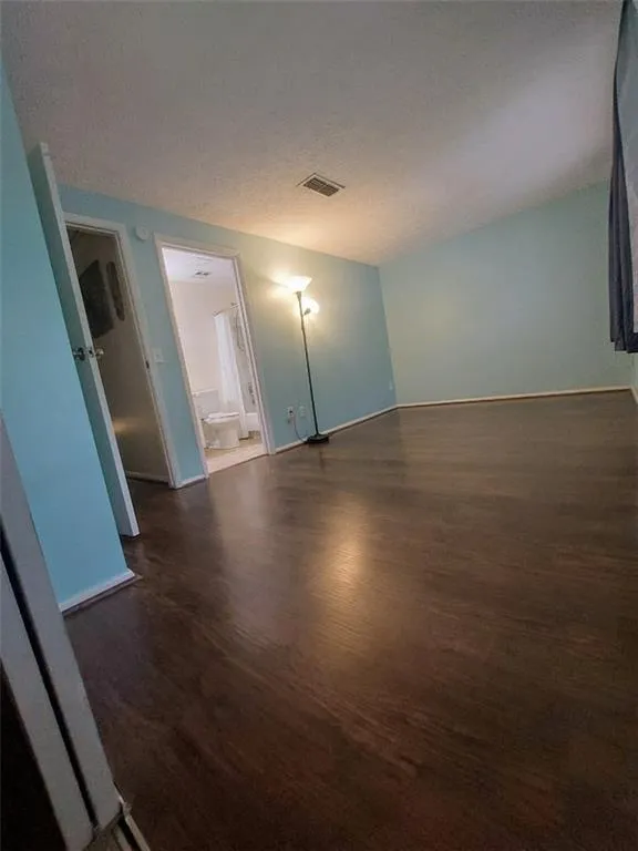 second bedroom with  dark hardwood / wood-style flooring