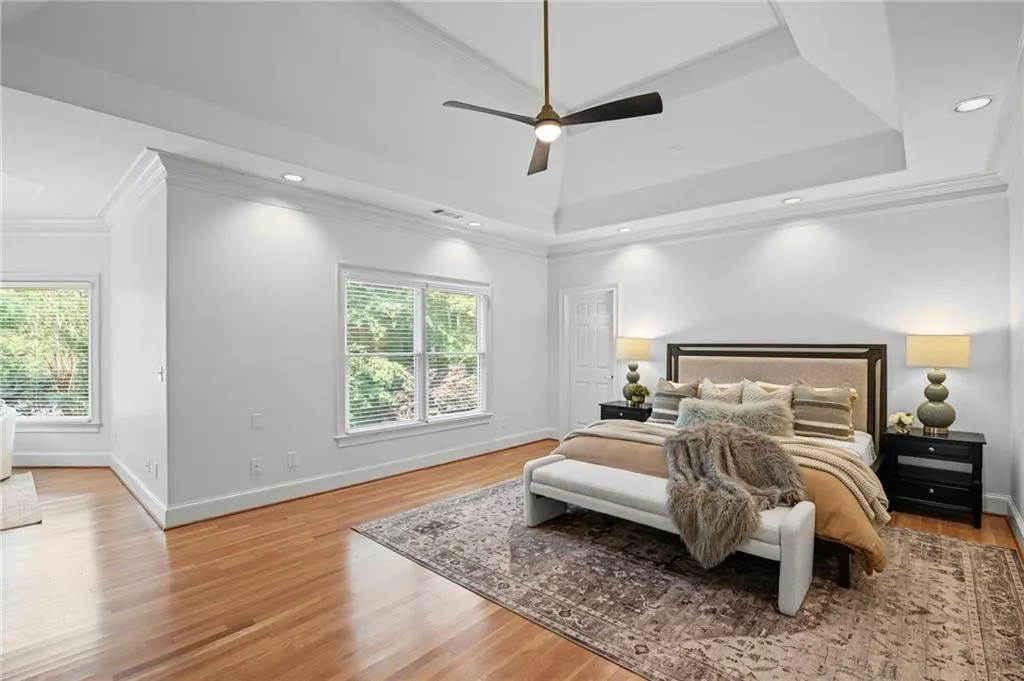 Oversized primary suite overlooking the private backyard