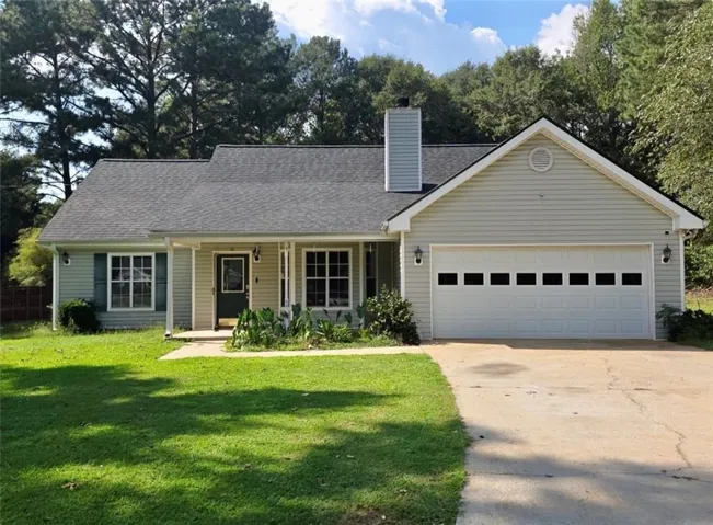 Light-colored siding exterior with a dark shingled roof