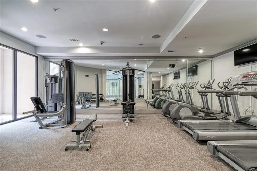 Modern gym facility with several treadmills and cable tv