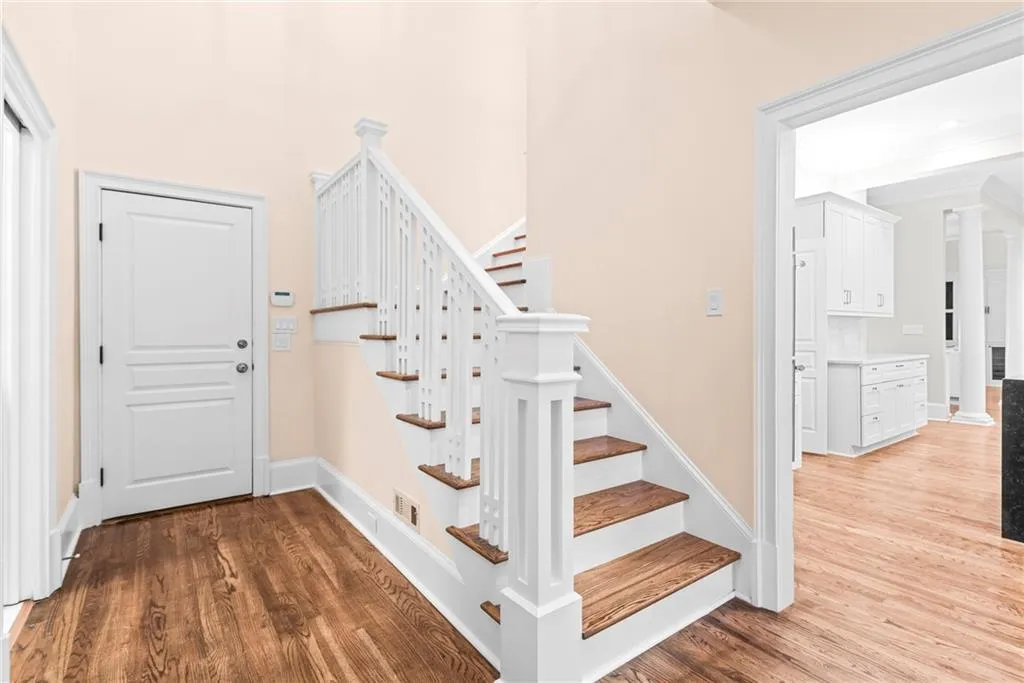 This staircase from the bedrooms comes down by the laundry room, garage, kitchen and pool bath!