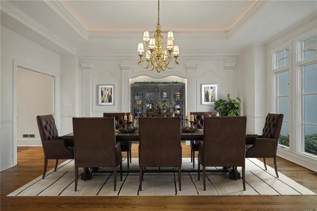 Cove lighting, down lighting on table and cove lighting provide great ambiance in this spacious dining room.