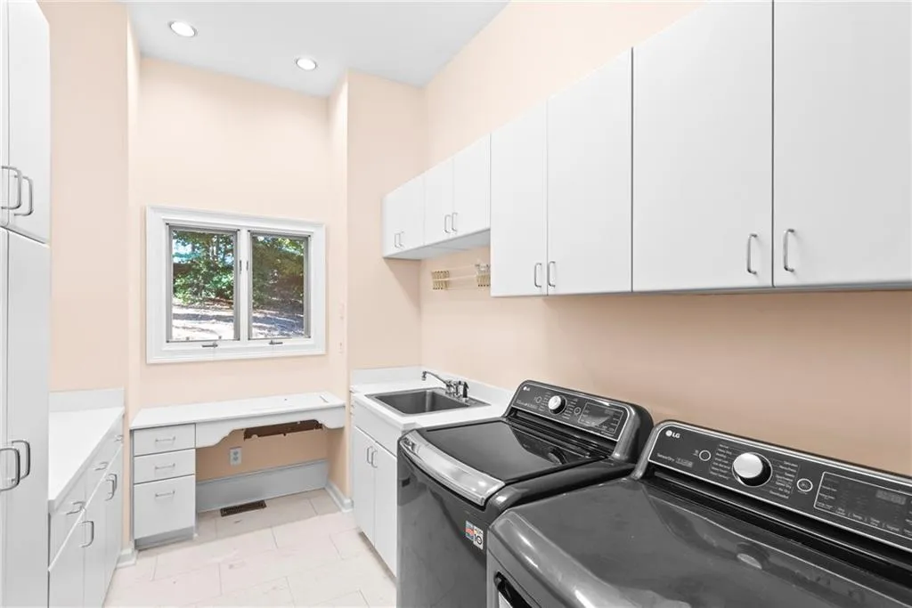 Lots of cabinets, laundry sink, sewing machine cabinet and room for a 2nd refrigerator/freezer