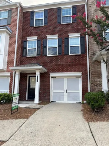 Brick facade with white trim and dark shutters