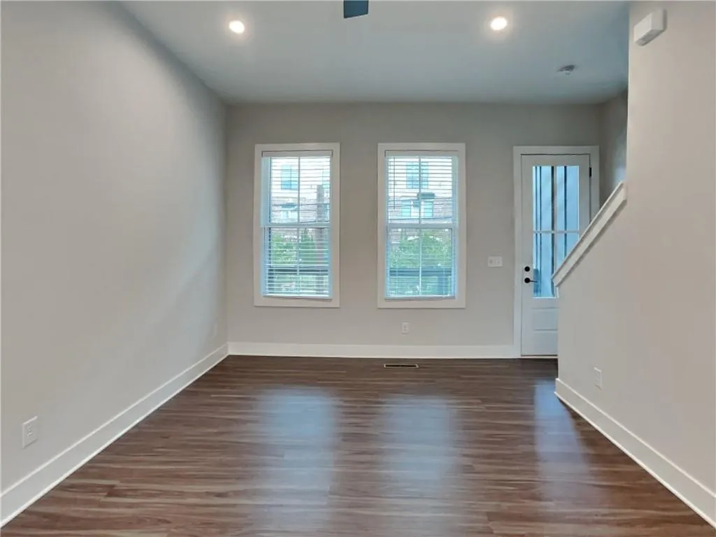 Foyer entrance featuring dark wood-style floors and recessed lighting