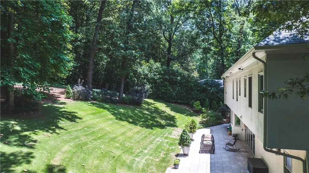 View of green lawn featuring a patio area