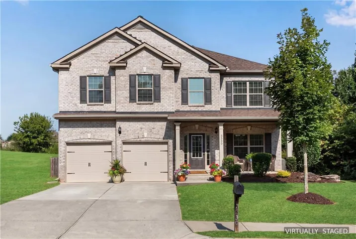 Brick facade with a covered front porch and arched window accents