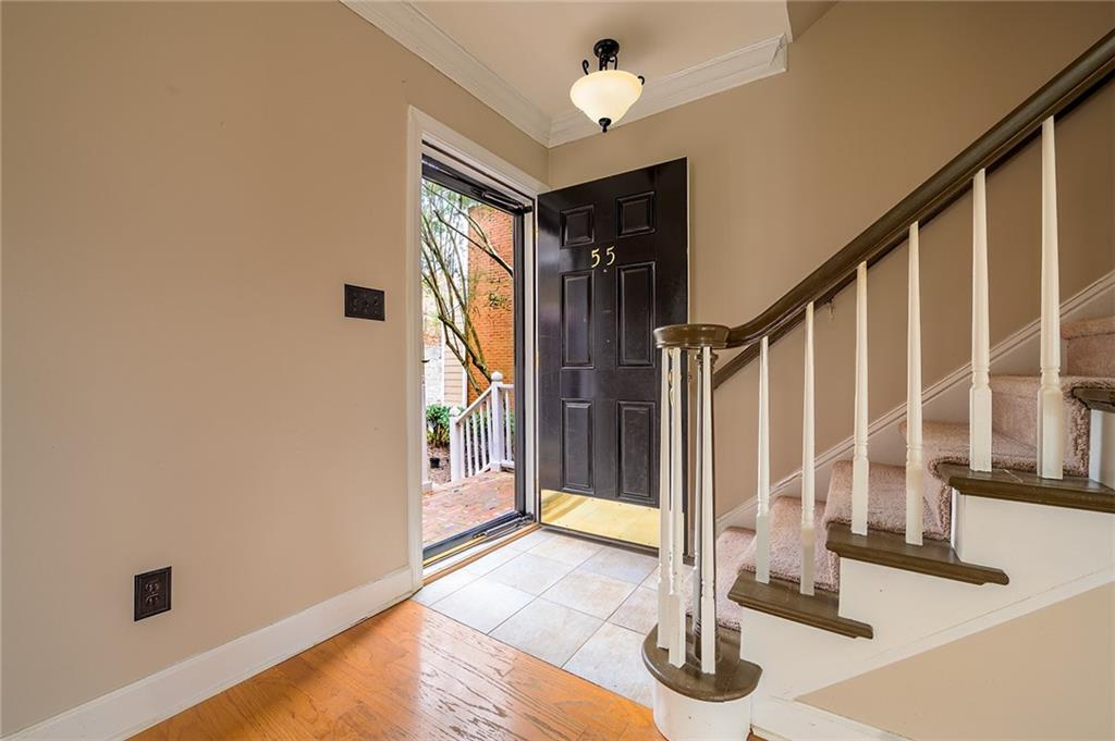 Tiled foyer with ornamental molding