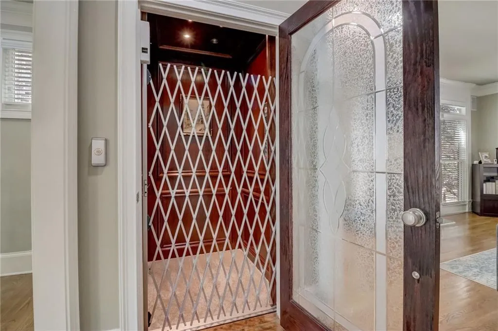 Wine room featuring a healthy amount of sunlight, crown molding, and wood-type flooring