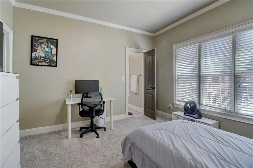 Carpeted bedroom featuring ornamental molding