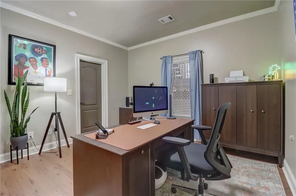 Office featuring light hardwood / wood-style floors and ornamental molding