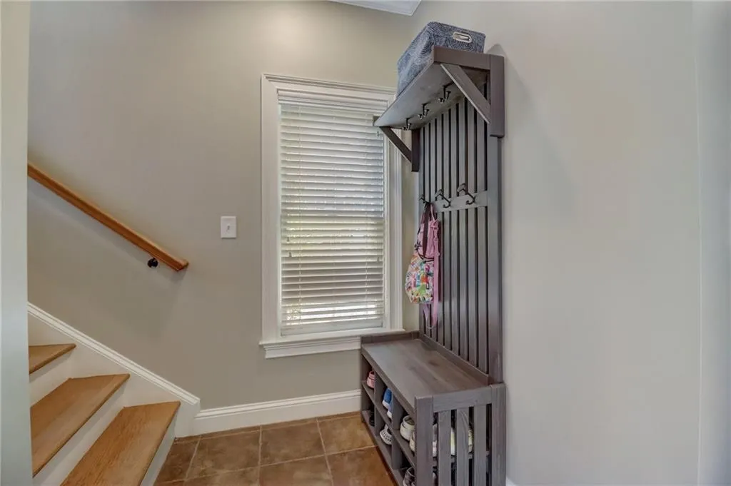 Mudroom featuring dark tile floors