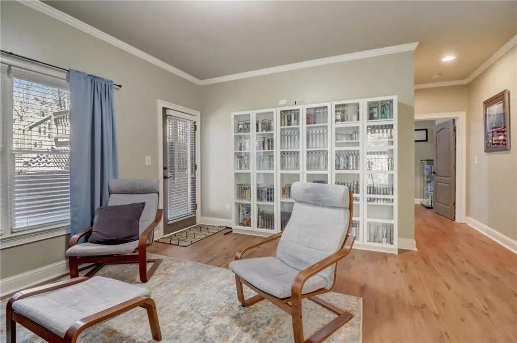 Living area featuring light hardwood / wood-style floors and crown molding