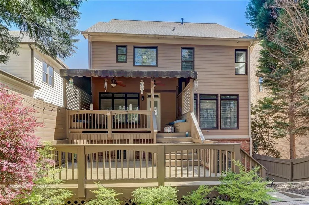 Back of property featuring a wooden deck