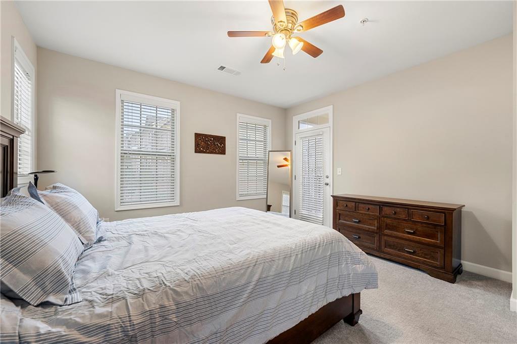Bedroom with light carpet and ceiling fan
