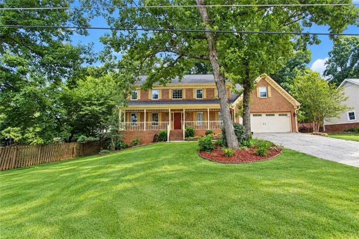 Brick exterior with a covered front porch featuring white railings