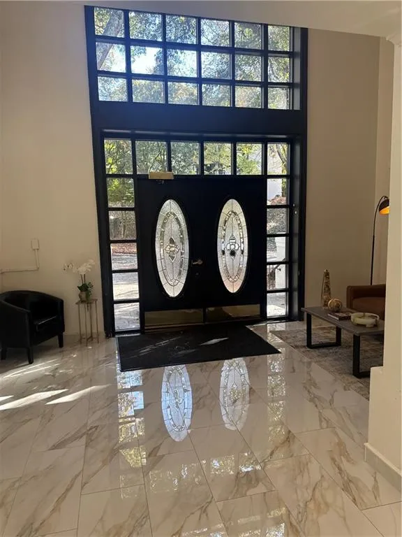 Entrance foyer with marble tiled flooring and french doors