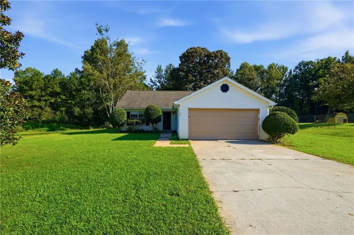 Ranch-style exterior with white siding, an attached garage, and a concrete driveway