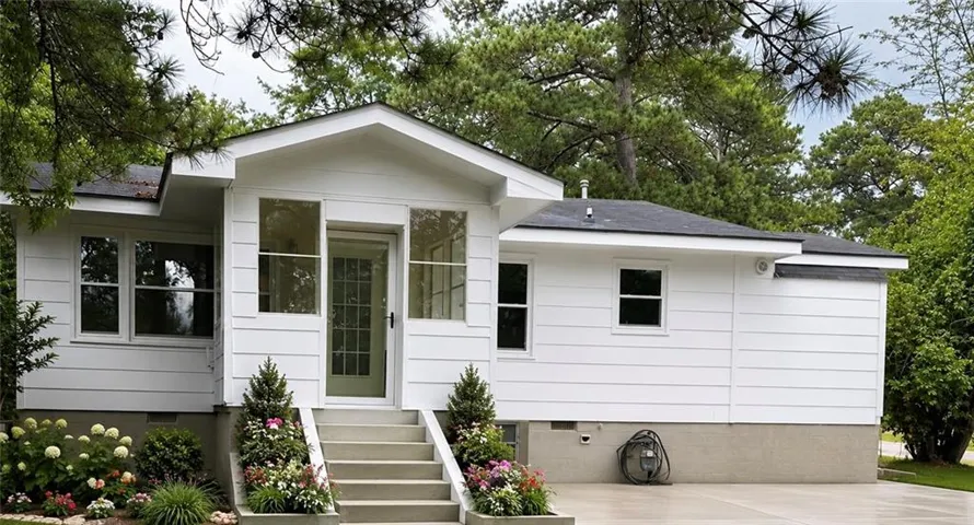 White horizontal siding exterior with a dark shingled roof