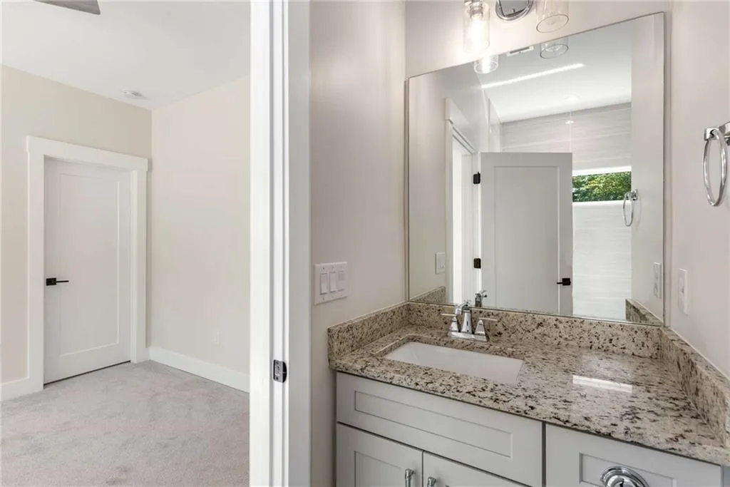 Bathroom featuring vanity and light colored carpet