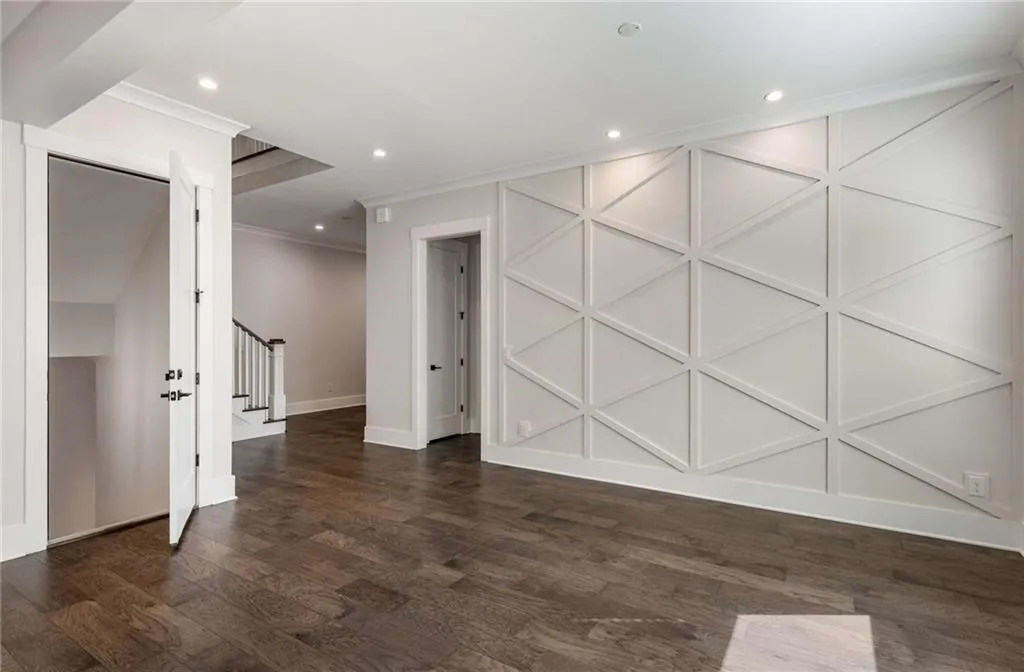 Spare room featuring stairs, dark wood finished floors, ornamental molding, and recessed lighting