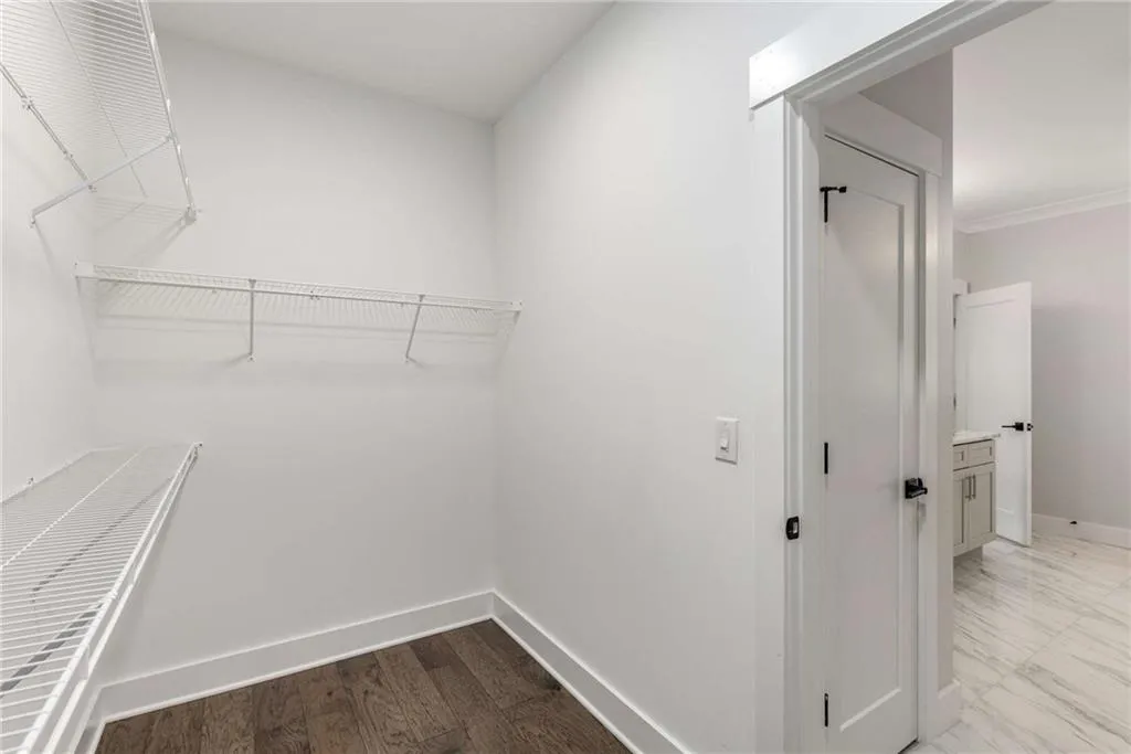 Spacious closet with light wood-style flooring