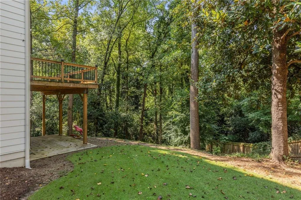 View of yard featuring a patio and a wooden deck