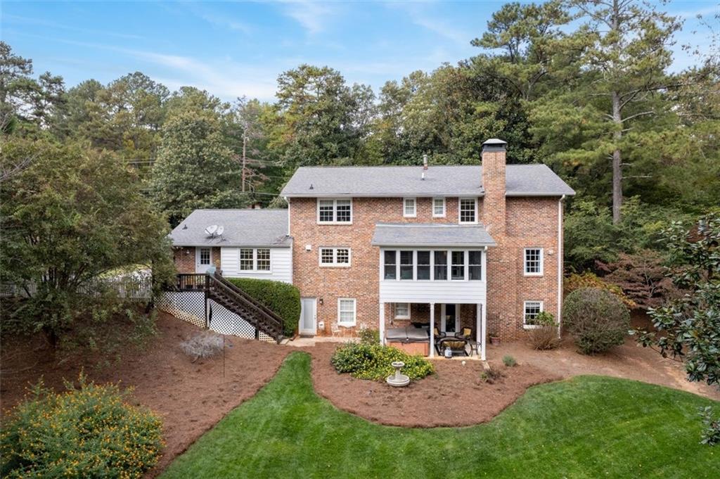 View of back of home and backyard