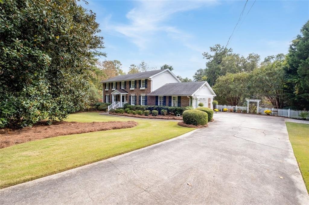 Front view of home and front yard from driveway entry