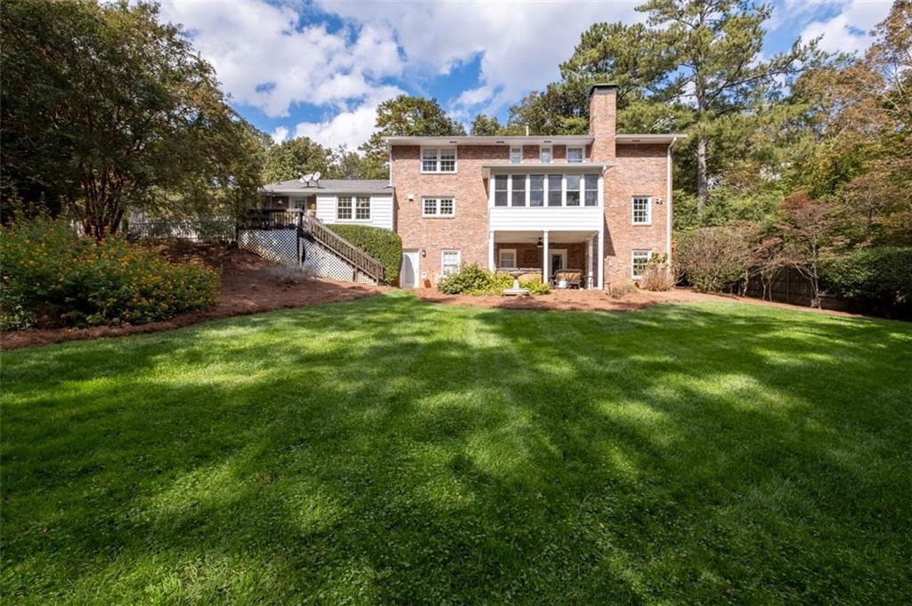 View of back of home and backyard