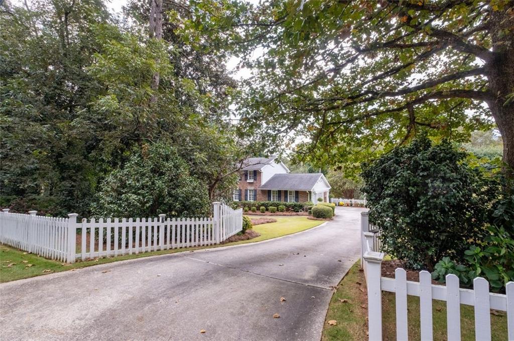 Front view of home and front yard from driveway entry