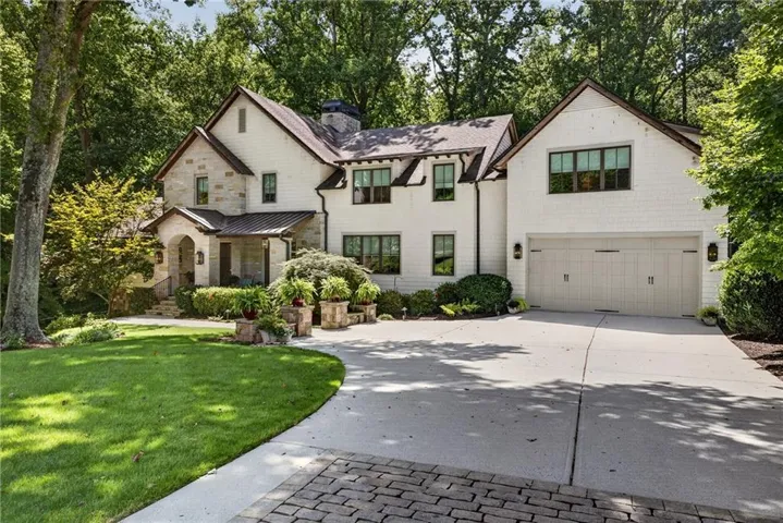 Stone and shingle exterior with a gabled roofline and dark-trimmed windows