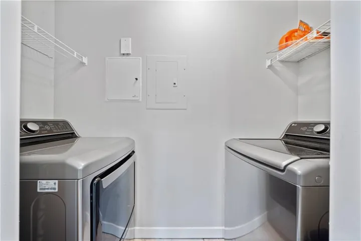 Laundry area with overhead wire shelving and light-colored walls