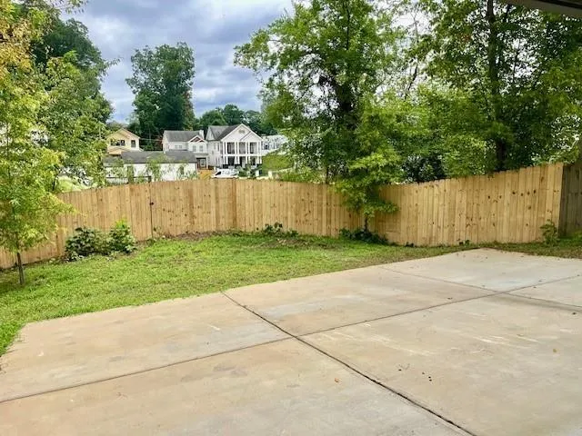 Fenced backyard with a patio area