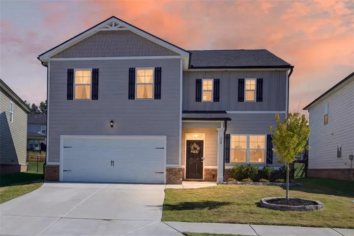 Two-story exterior with mixed siding, a two-car garage, and a covered entry