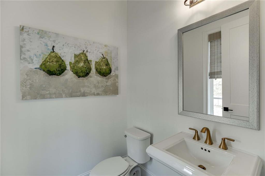 The powder room is nestled off the kitchen.