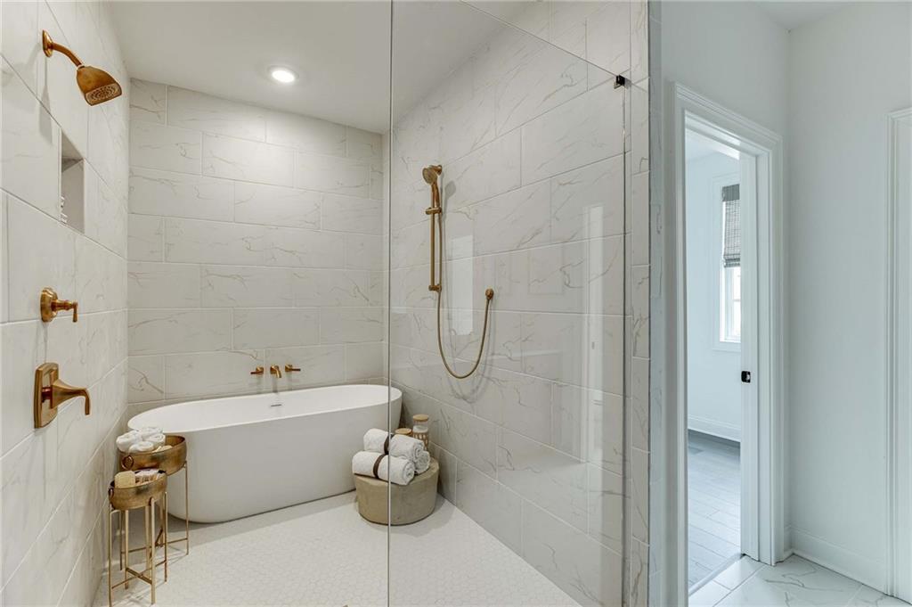 Gold fixtures in the Primary bath add to the beauty.