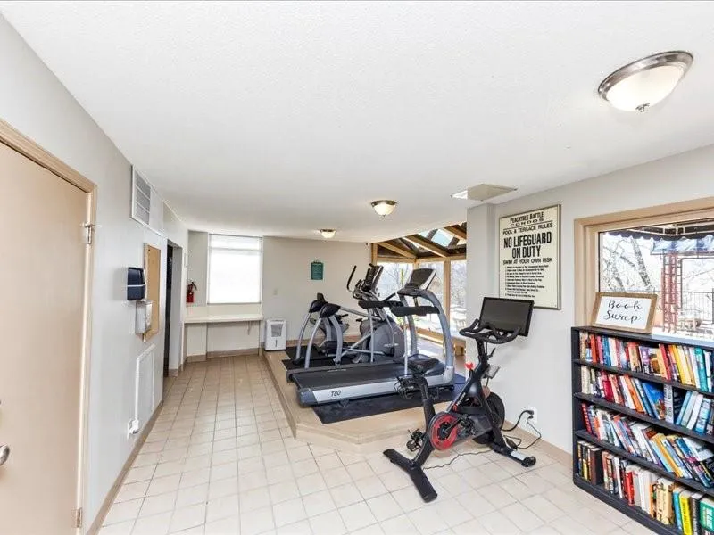 Exercise area with light tile patterned floors and visible vents