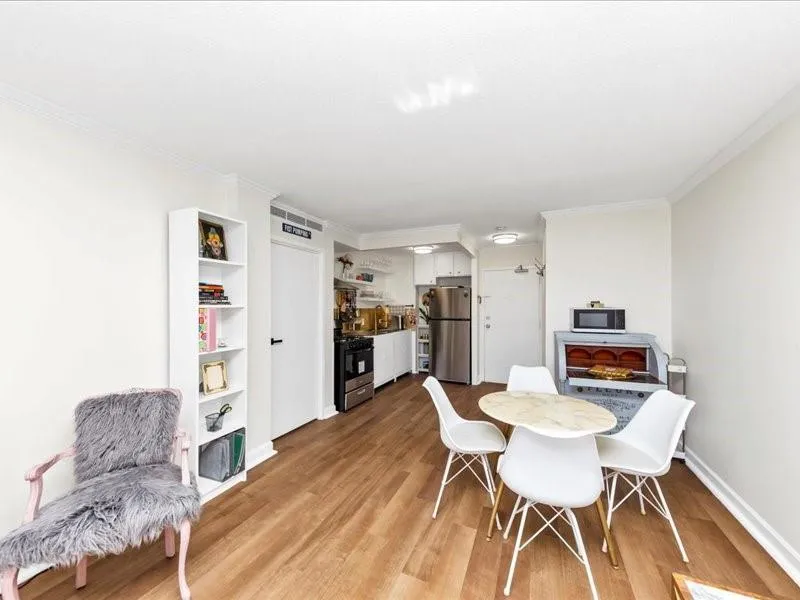 Dining area featuring light wood-type flooring, baseboards, and ornamental molding