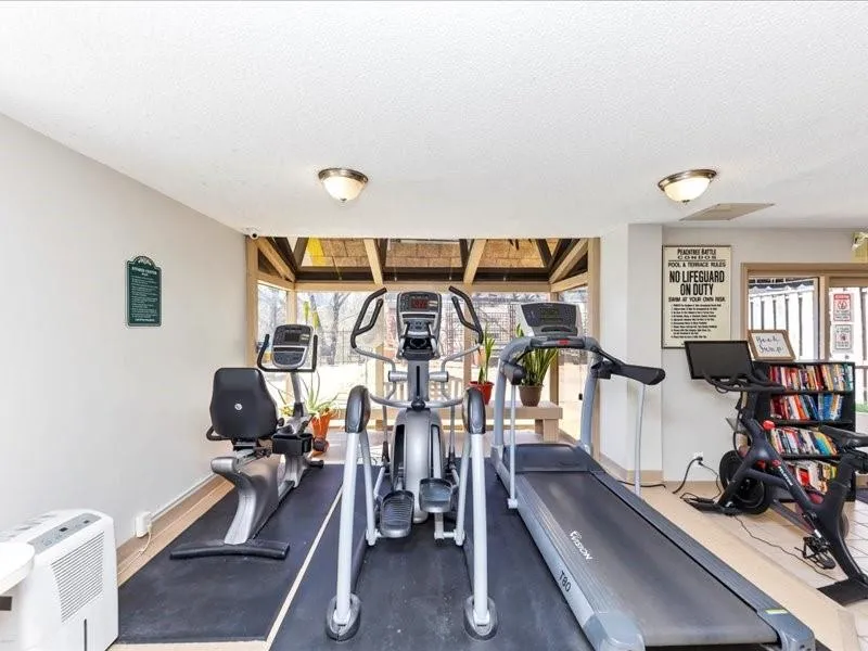 Exercise area with baseboards and a textured ceiling
