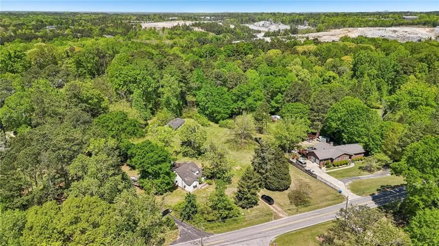 Aerial view featuring a forest view