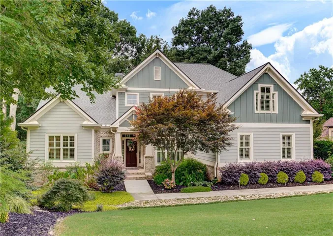 Contemporary Craftsman-style residence featuring a prominent gable roofline and a varied siding facade