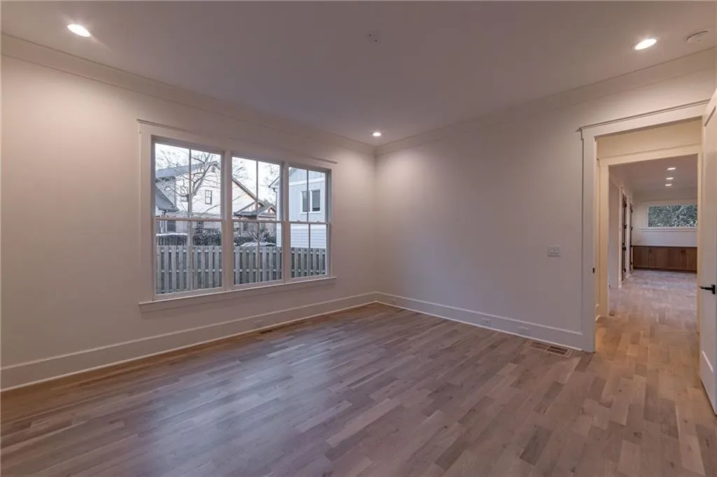 Unfurnished room featuring wood finished floors, crown molding, and recessed lighting