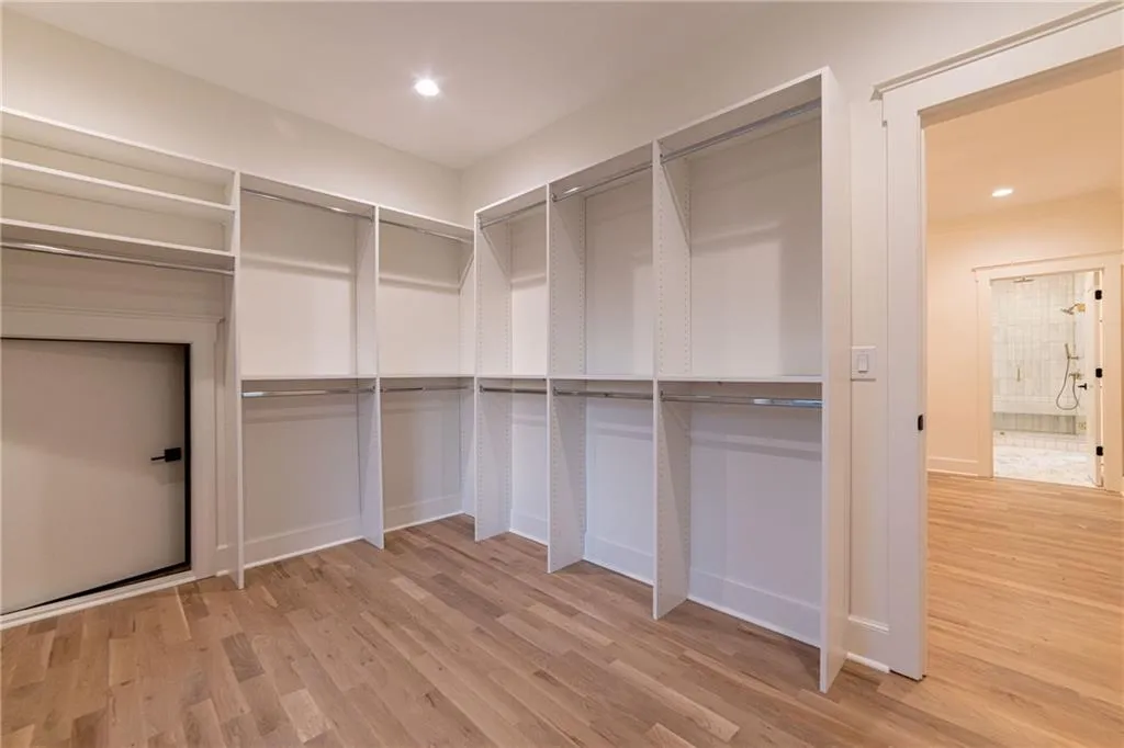 Walk in closet featuring light wood finished floors