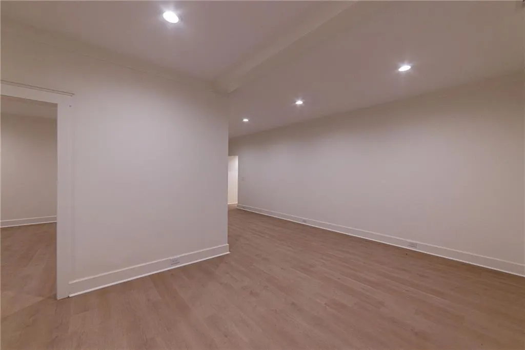 Unfurnished room with wood finished floors, recessed lighting, and ornamental molding