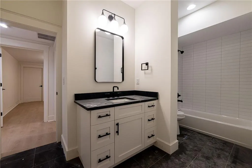 Bathroom featuring vanity, shower / tub combination, recessed lighting, and tile patterned flooring